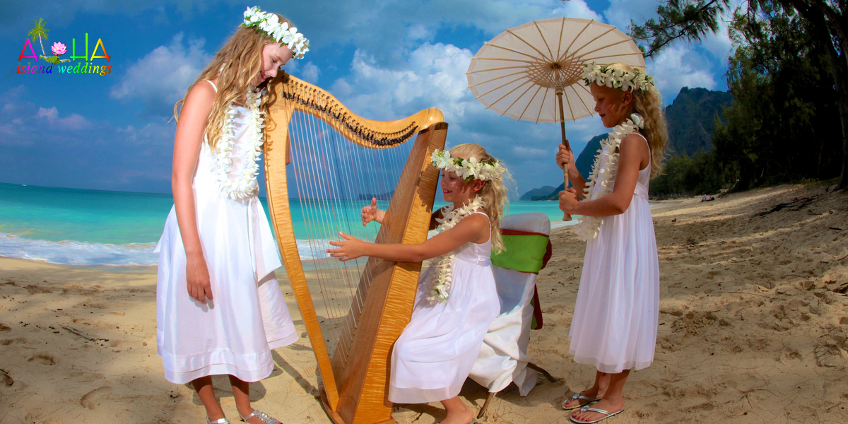 flower girls dancing around the harp on the beach